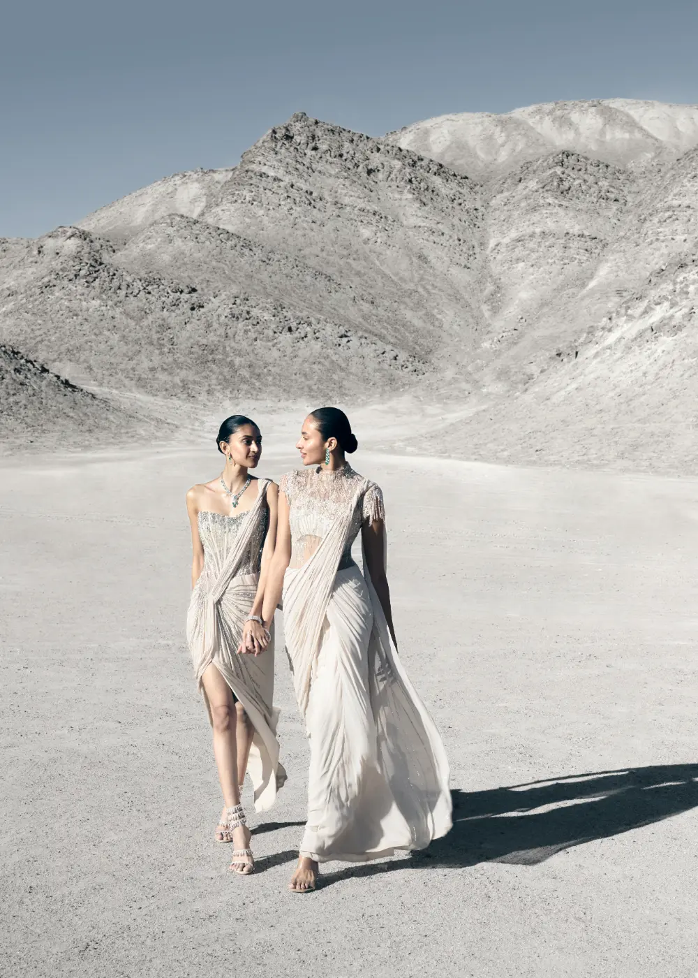 Dhyany, left, in a saree gown and corset, and Sonalee, right, in a saree gown with high-neck embroidered yoke, and pleating across bodice